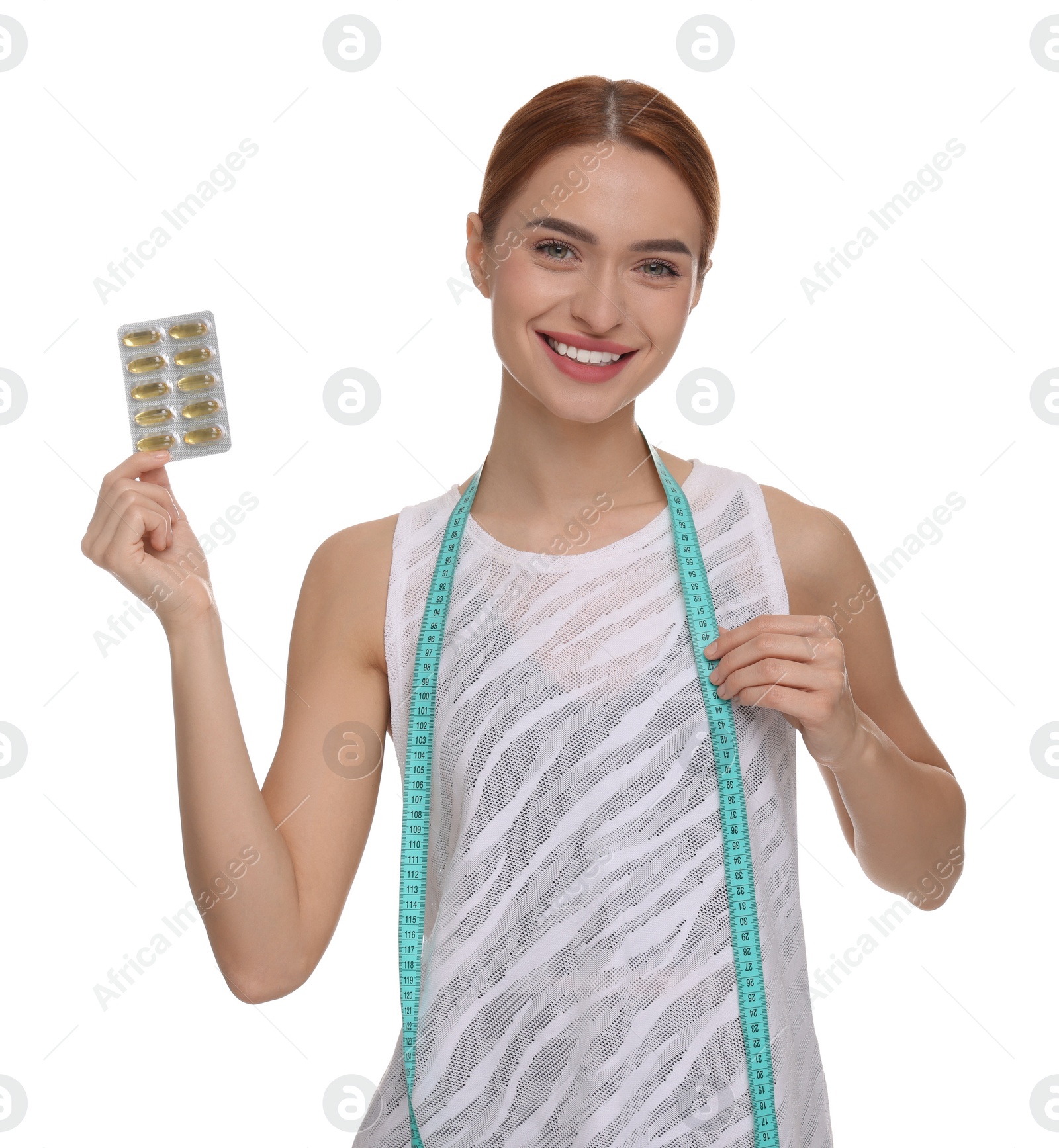 Photo of Happy young woman with pills and measuring tape on white background. Weight loss