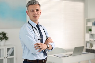 Portrait of doctor with stethoscope in clinic, space for text