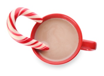 Photo of Cup of tasty cocoa with Christmas candy cane isolated on white, top view