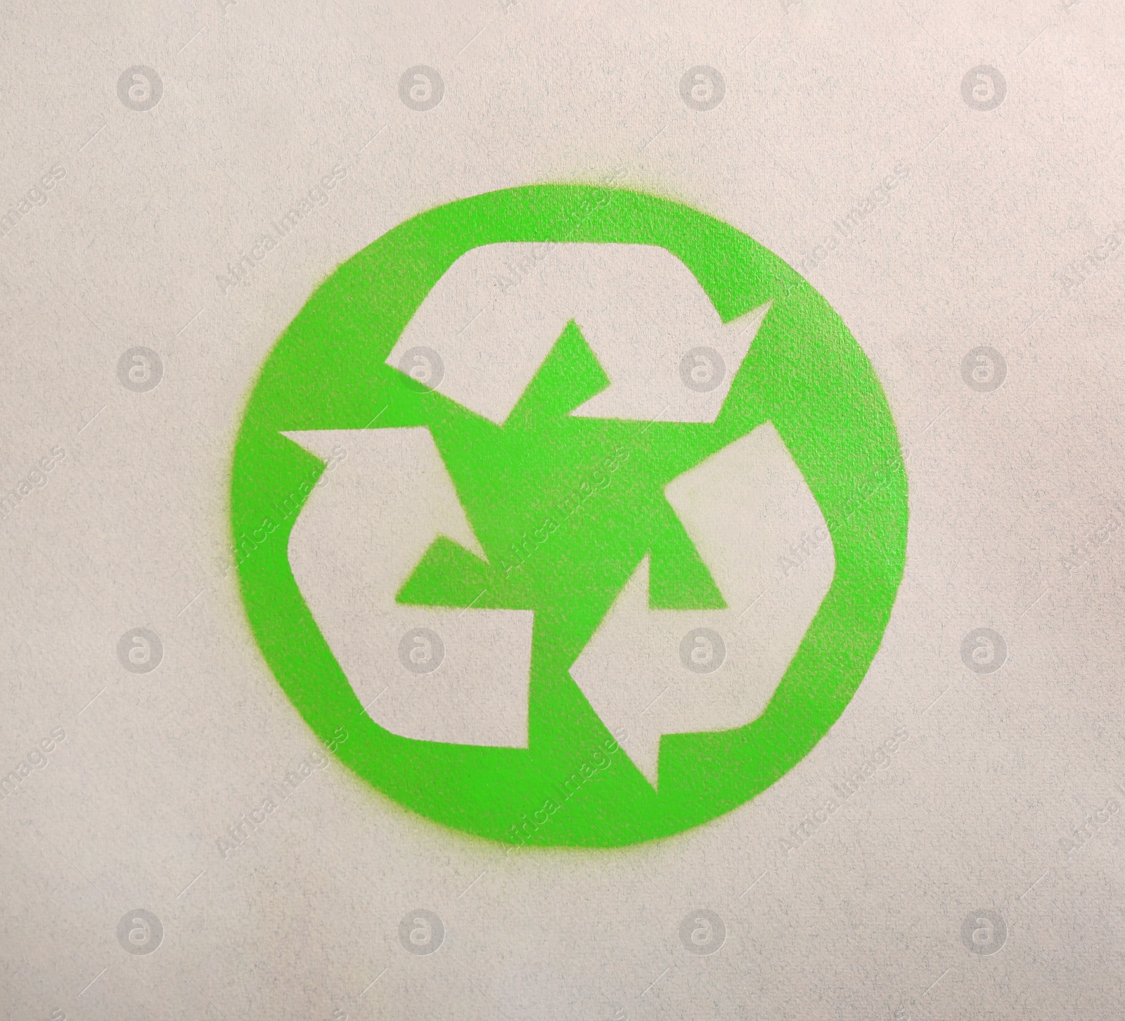 Photo of Recycling symbol on cardboard paper, top view