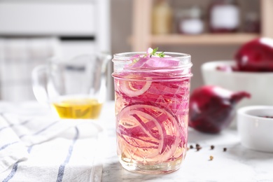 Jar of pickled onions on table indoors