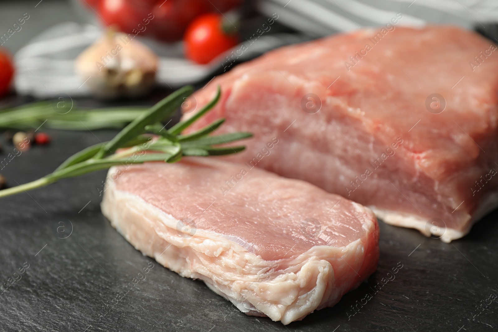 Photo of Fresh raw cut meat on grey table, closeup