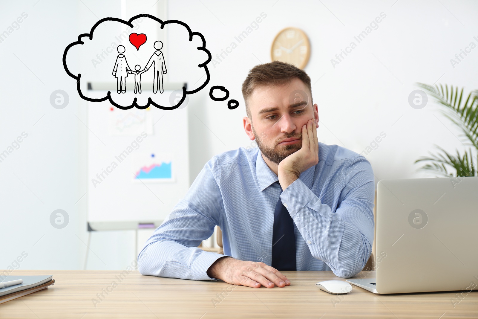 Image of Businessman dreaming about family in office. Concept of balance between life and work