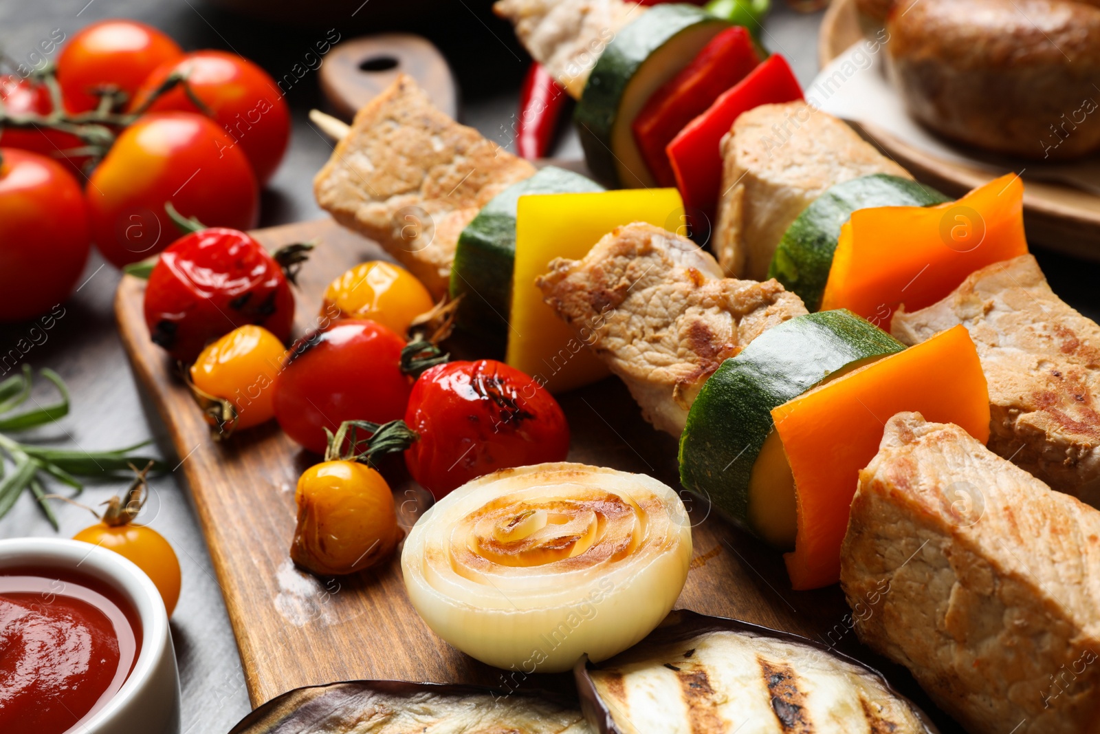 Photo of Barbecued meat and vegetables on table, closeup