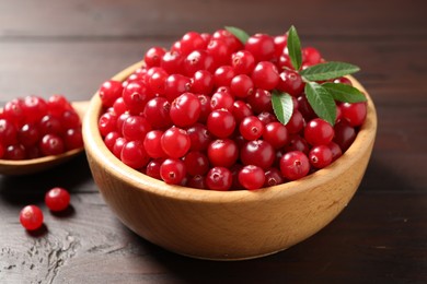 Photo of Fresh ripe cranberry on wooden table, closeup