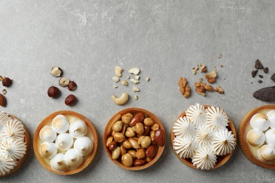 Many different tartlets on grey table, flat lay with space for text. Delicious dessert