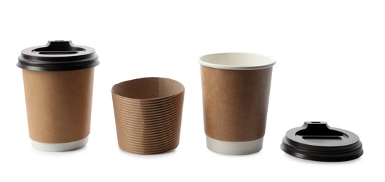 Photo of Takeaway paper coffee cups and sleeve on white background