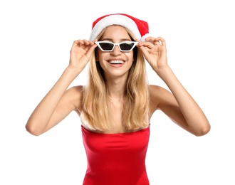 Photo of Young woman wearing Santa Claus hat on white background. Christmas vacation