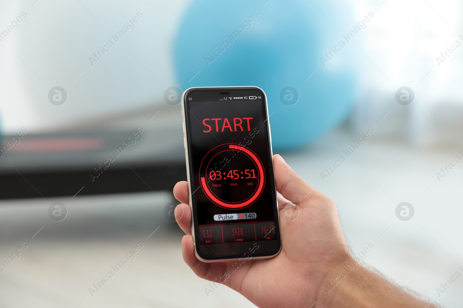 Photo of Man using fitness app on smartphone indoors, closeup