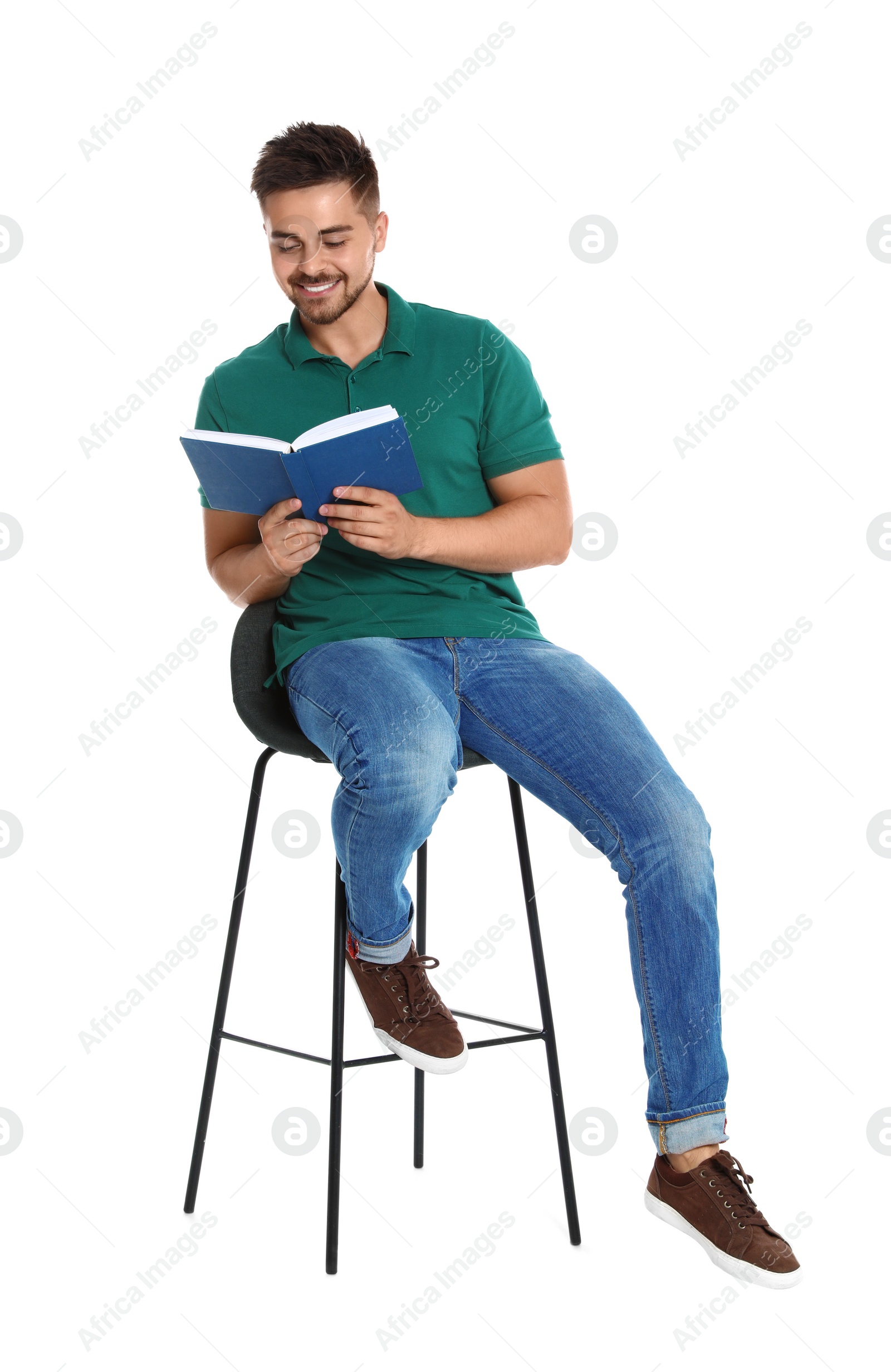 Photo of Handsome young man reading book on white background