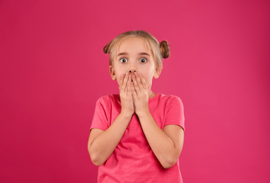 Photo of Cute little girl posing on pink background