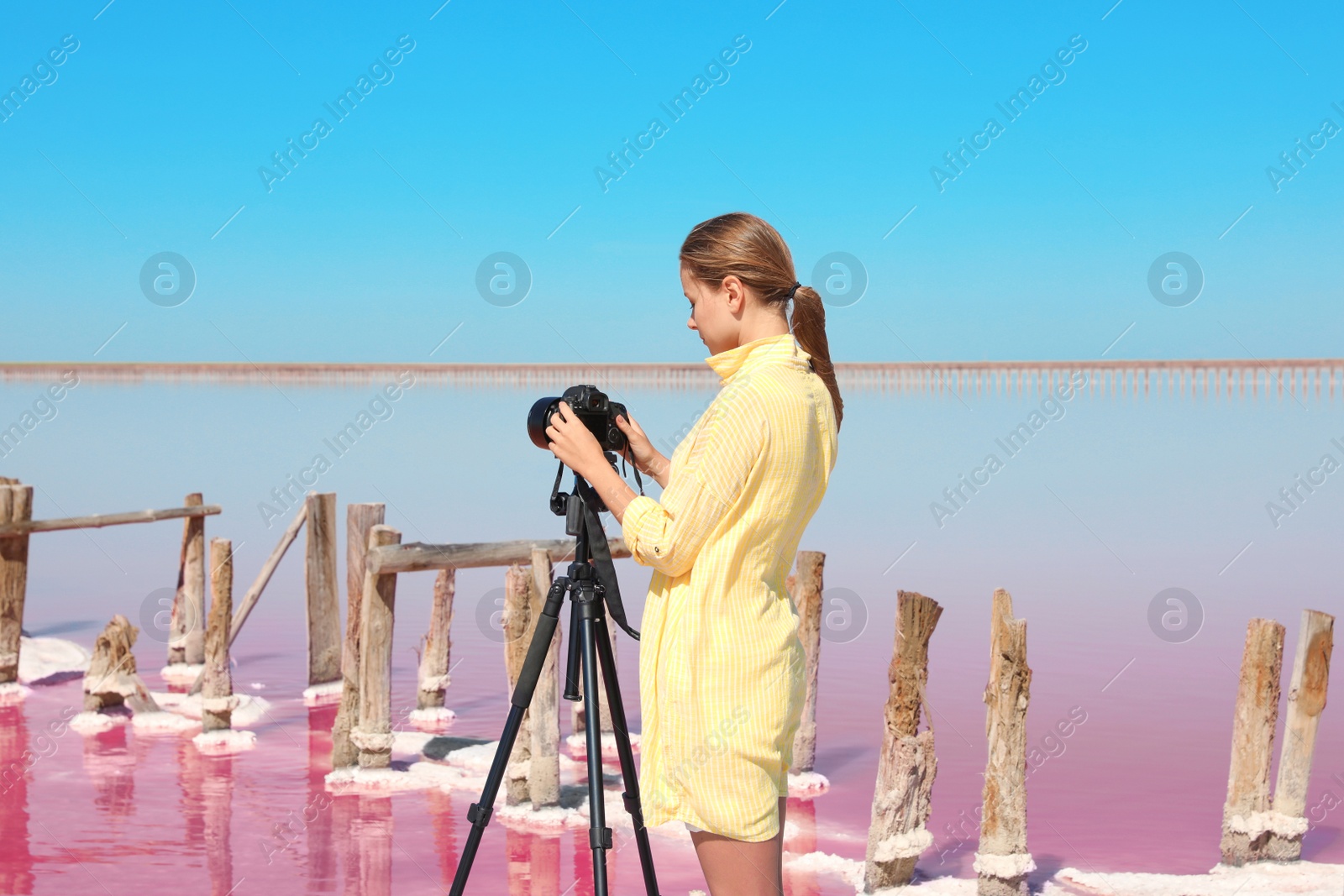 Photo of Professional photographer taking photo of pink lake on sunny day