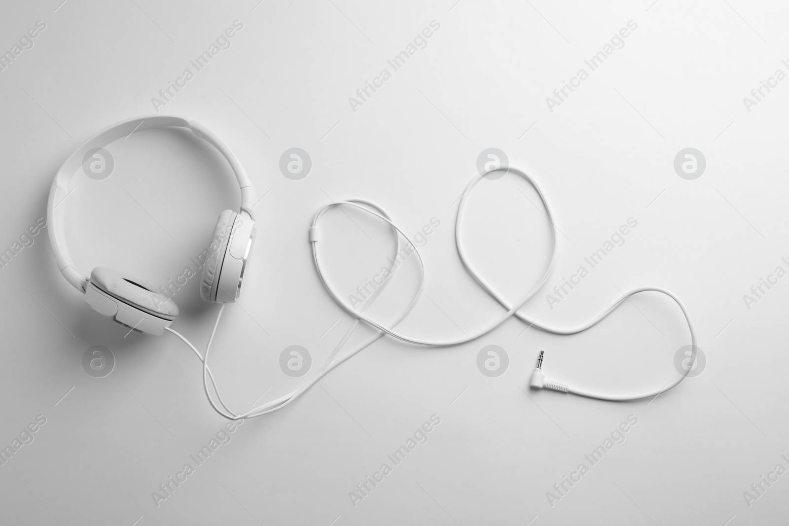 Photo of Stylish modern headphones with earmuffs on white background, top view