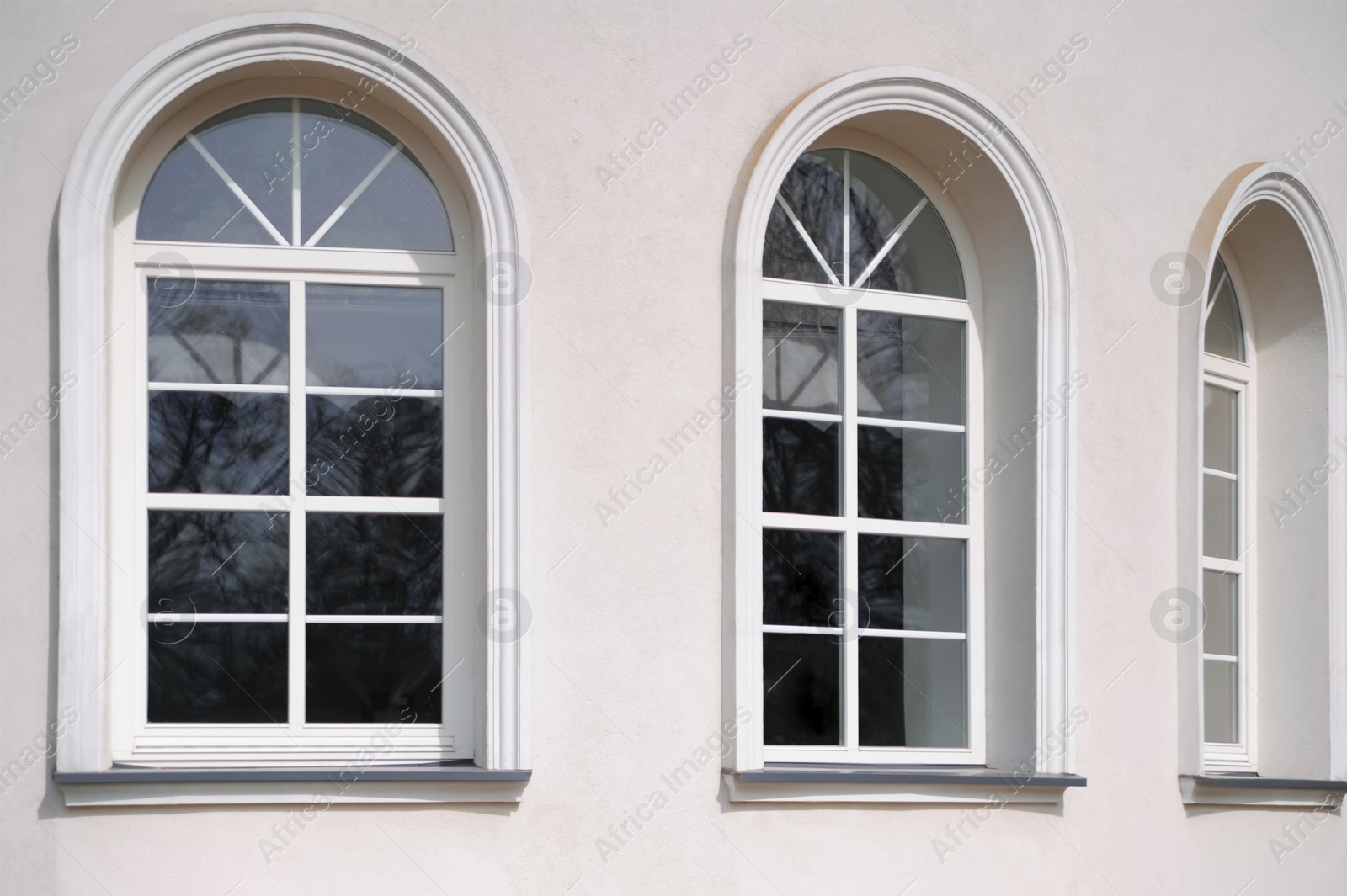 Photo of Beautiful arched windows in building, view from outdoors