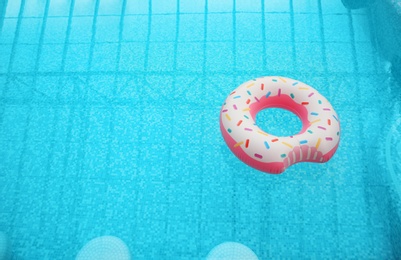 Photo of Inflatable ring floating on water in swimming pool