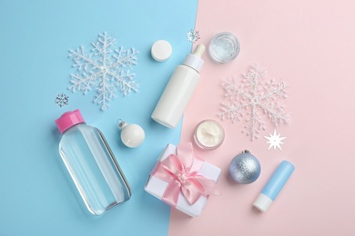 Flat lay composition with different cosmetic products on color background. Winter care