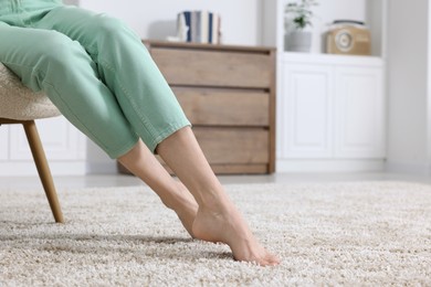 Photo of Woman on soft light brown carpet at home, closeup. Space for text