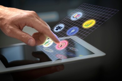 Image of Marketing. Man touching virtual icon over tablet against blurred background, closeup