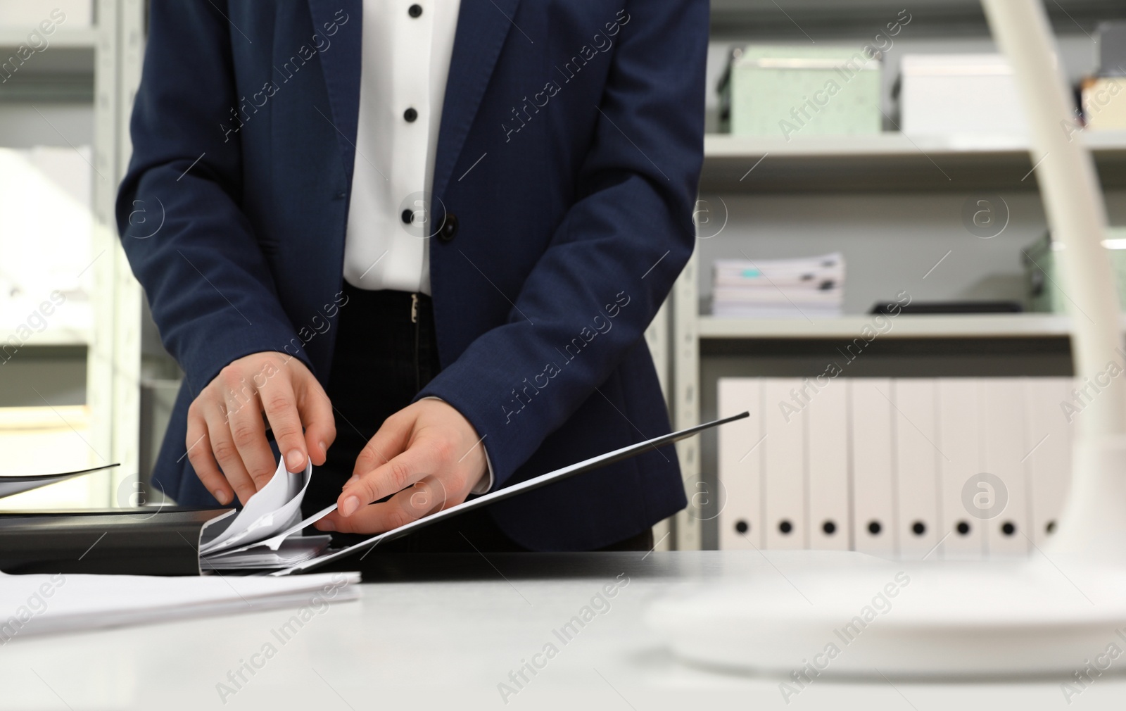 Photo of Woman working with documents at table in office, closeup