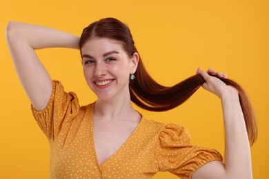 Photo of Portrait of smiling woman on yellow background