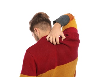 Photo of Young man scratching back on white background. Annoying itch