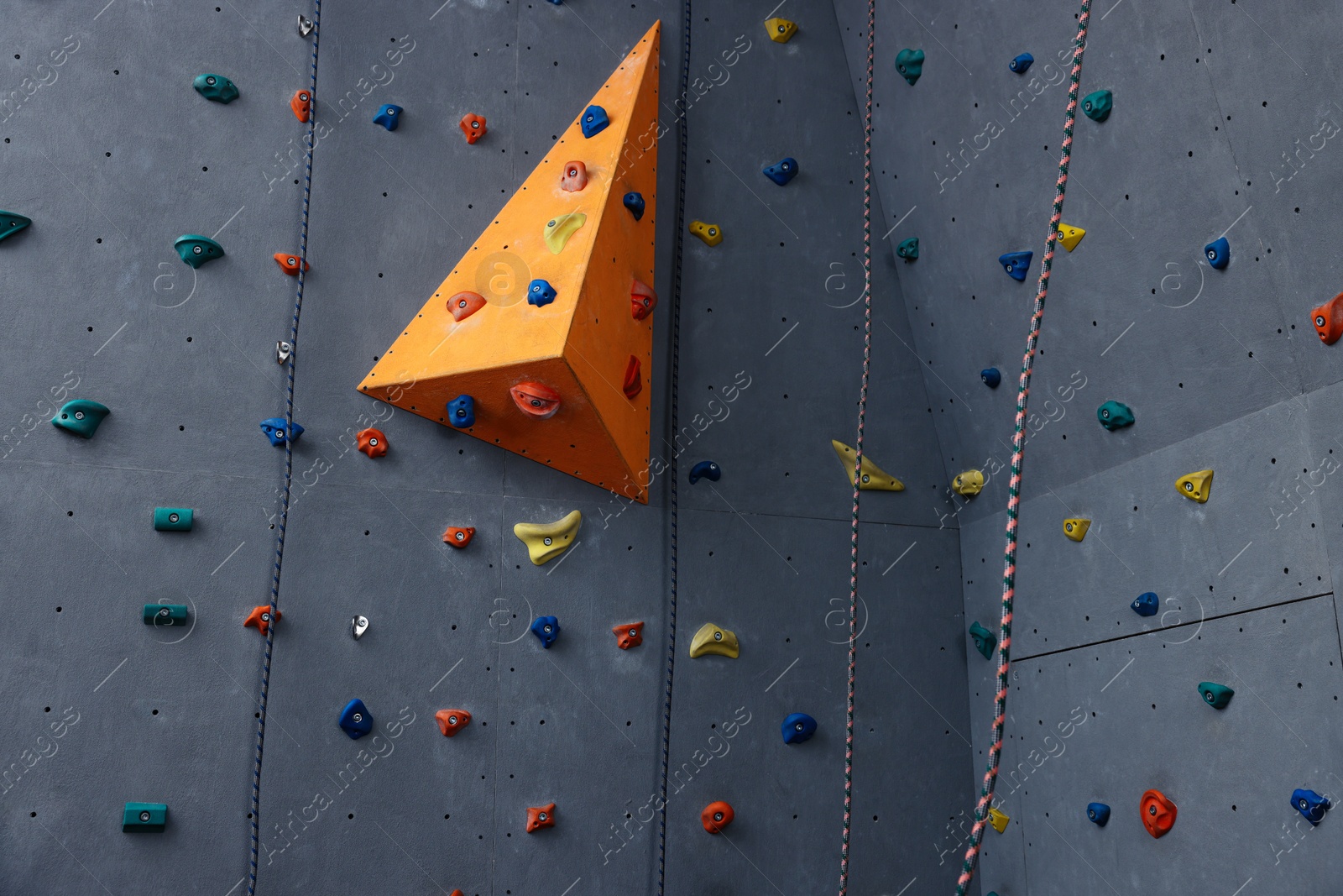 Photo of Climbing wall with holds in gym. Extreme sport