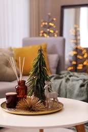 Photo of Composition with decorative Christmas tree and reindeer on white table in living room
