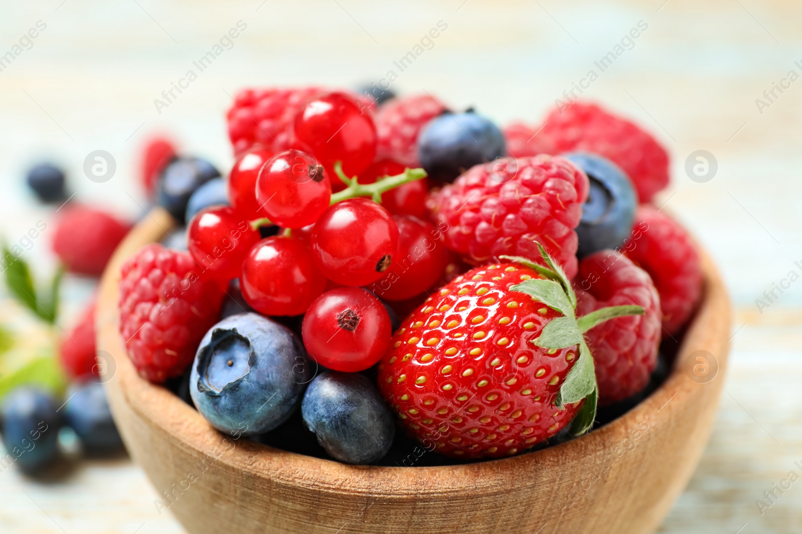 Photo of Mix of different fresh berries in bowl on table, closeup