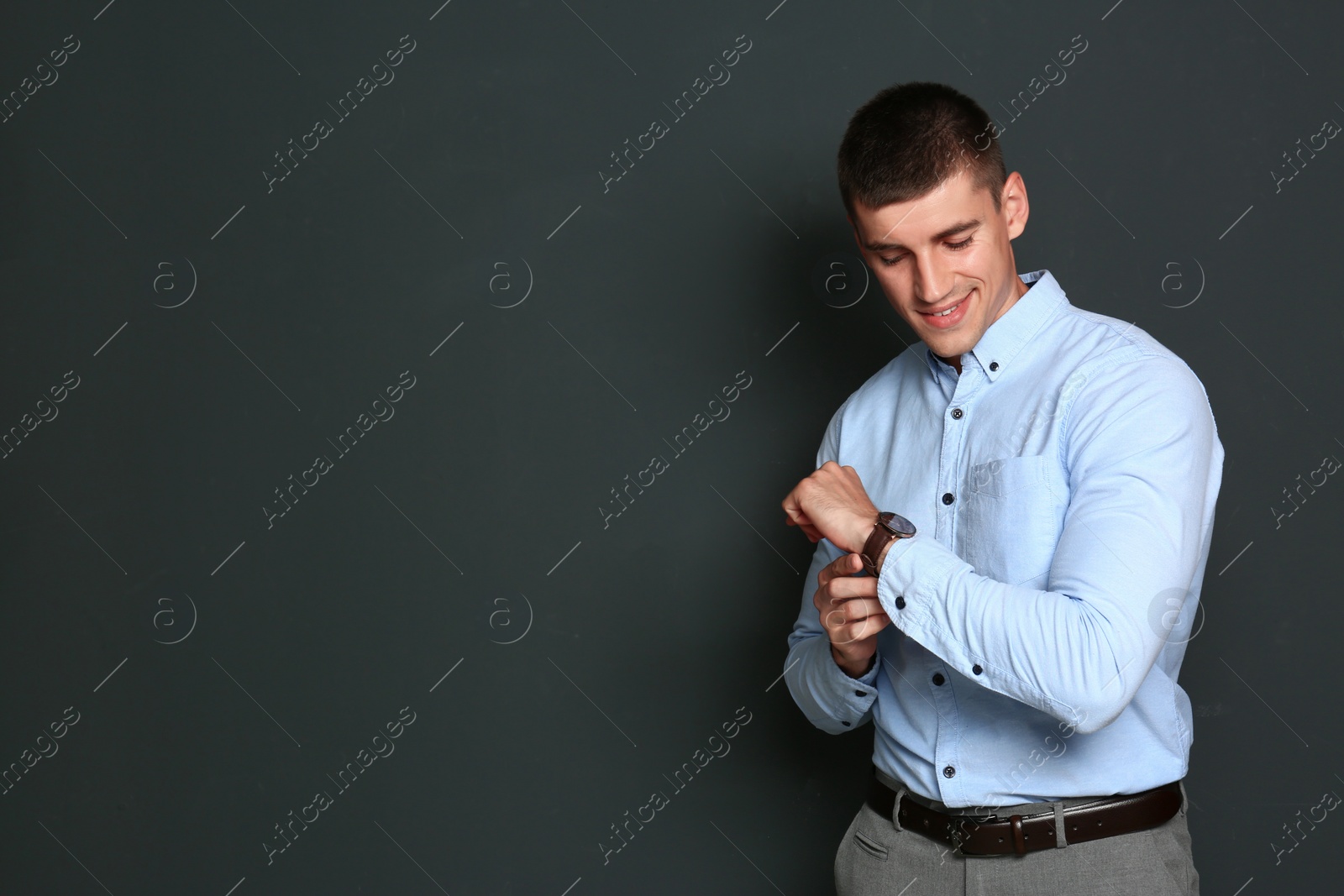 Photo of Portrait of handsome young man on dark background. Space for text