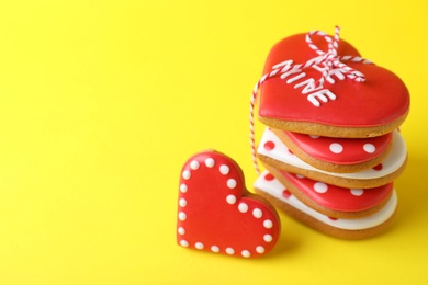 Photo of Gift set of heart shaped cookies on yellow background, closeup with space for text. Valentine's day treat