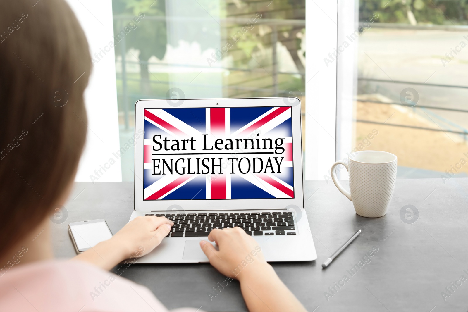 Image of Woman using laptop for online English learning at home, closeup