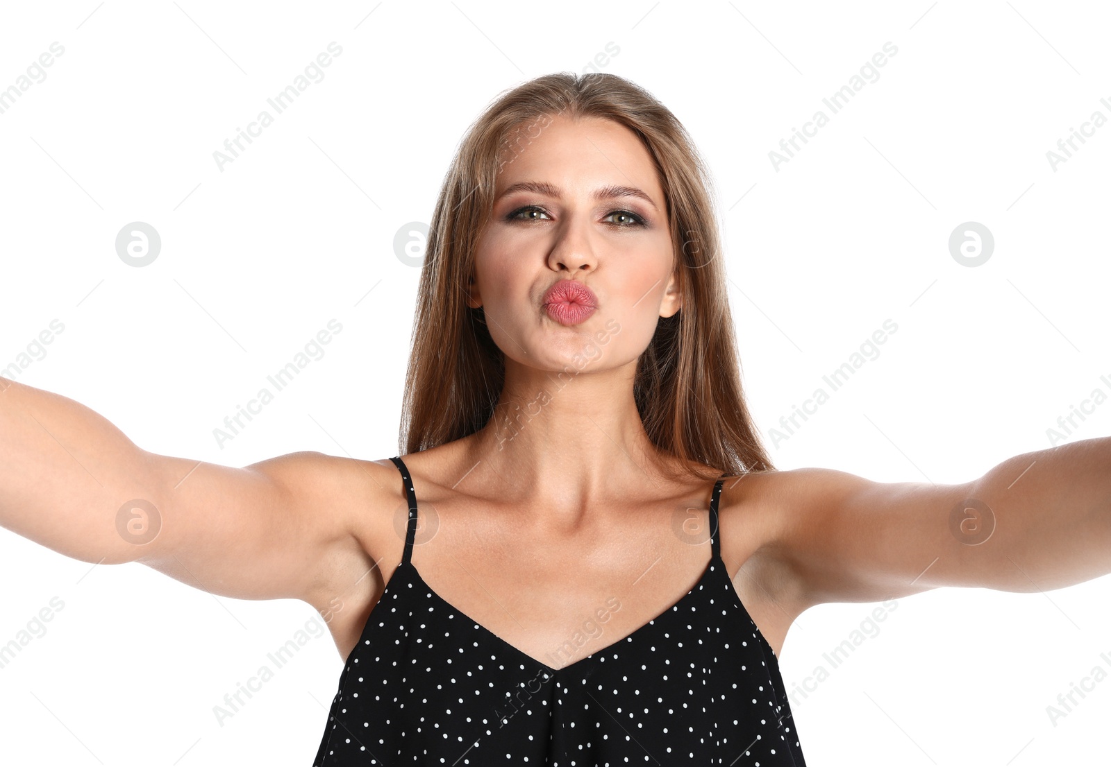 Photo of Flirty young woman taking selfie on white background