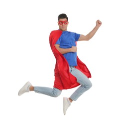 Man in superhero cape and mask jumping on white background