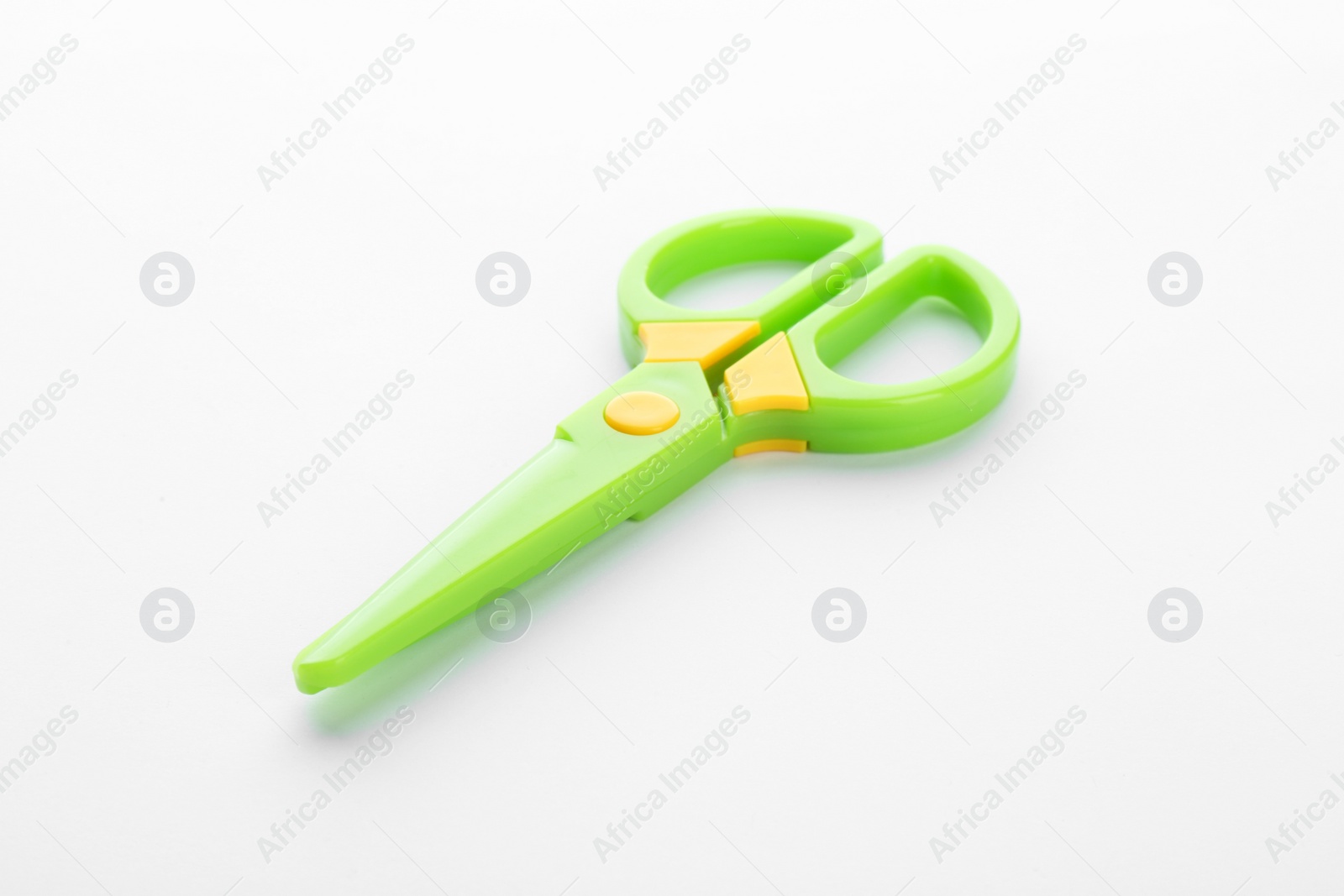 Photo of Colorful plastic scissors on white background. School stationery