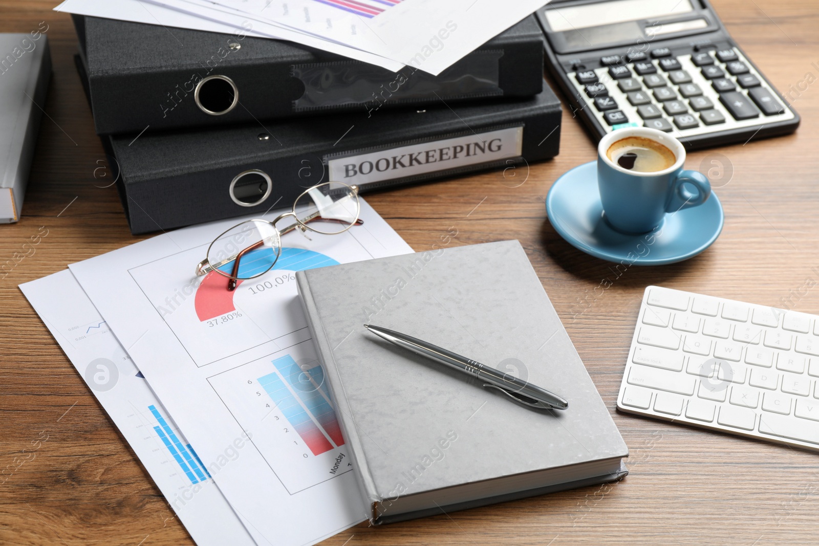 Photo of Bookkeeper's workplace with folders and documents on table