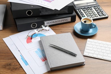 Photo of Bookkeeper's workplace with folders and documents on table