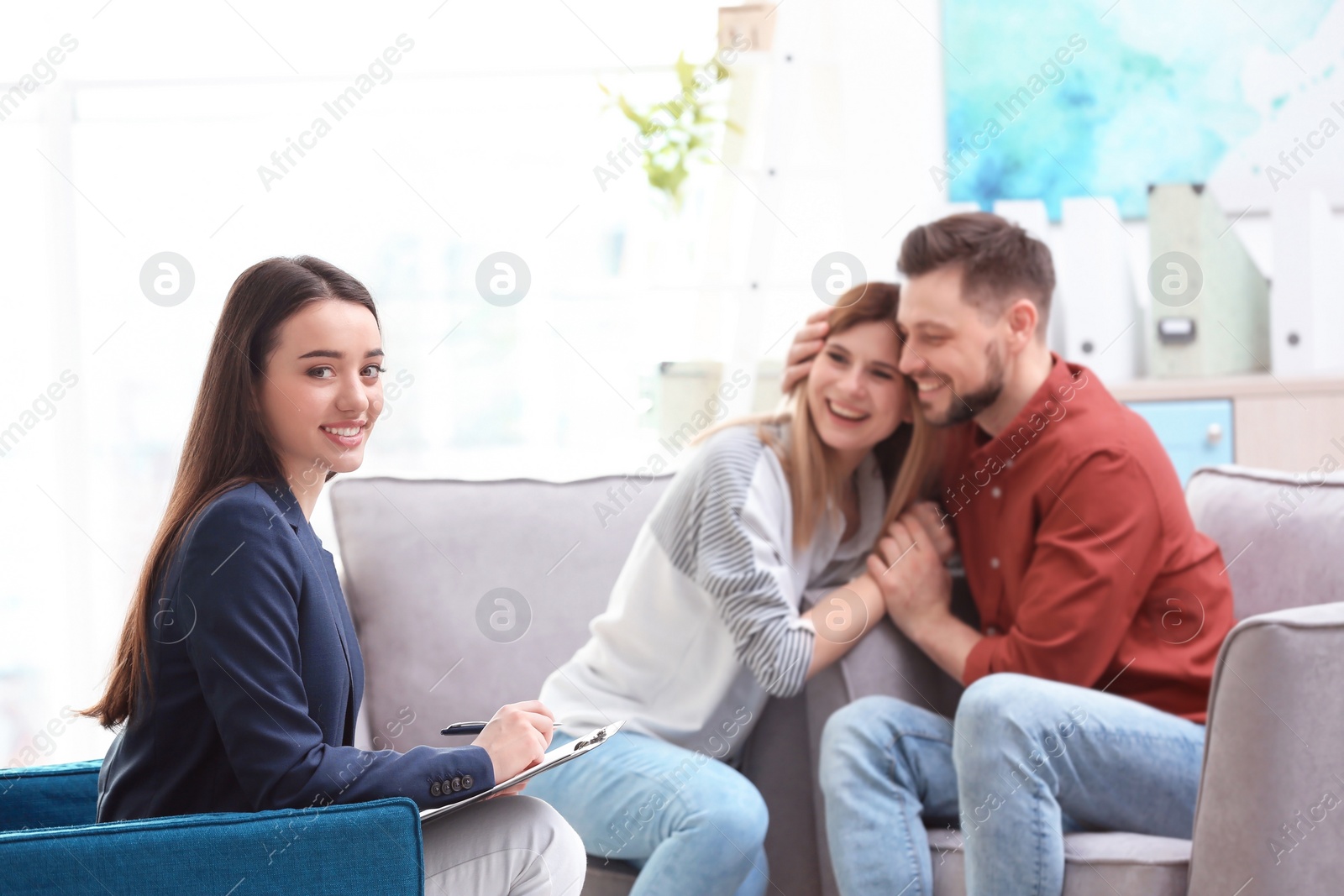 Photo of Professional psychologist and young couple in office