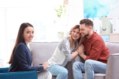 Professional psychologist and young couple in office