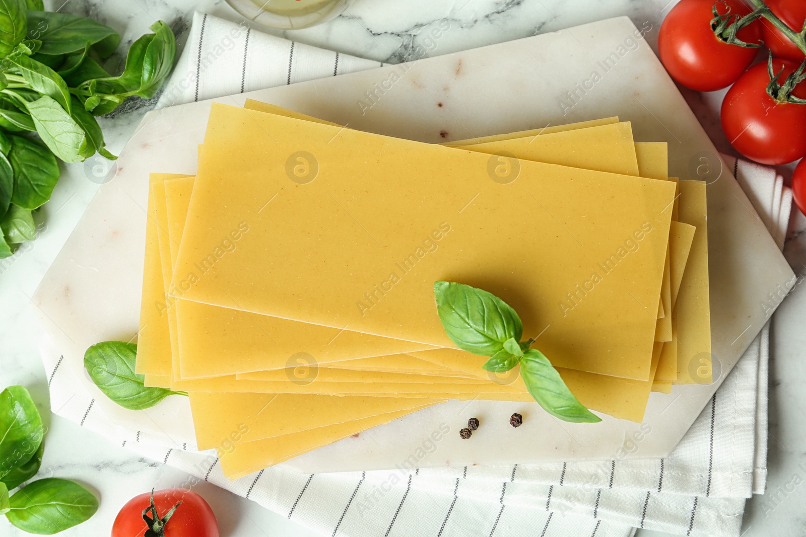 Photo of Flat lay composition with uncooked lasagna sheets on white marble table