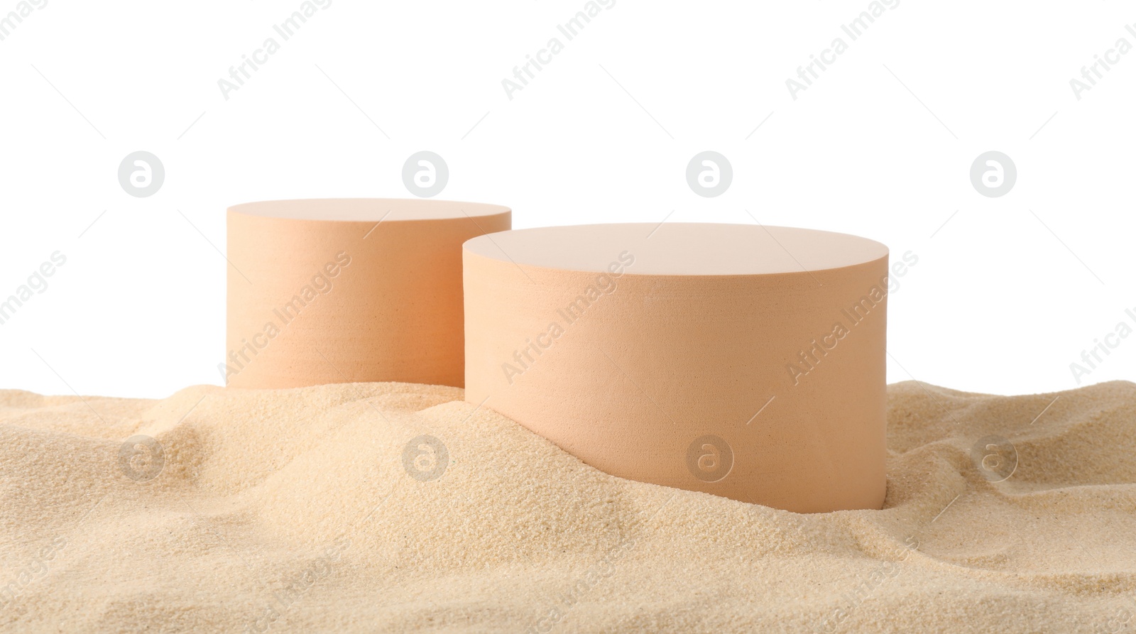 Photo of Presentation of product. Different podiums on sand against white background