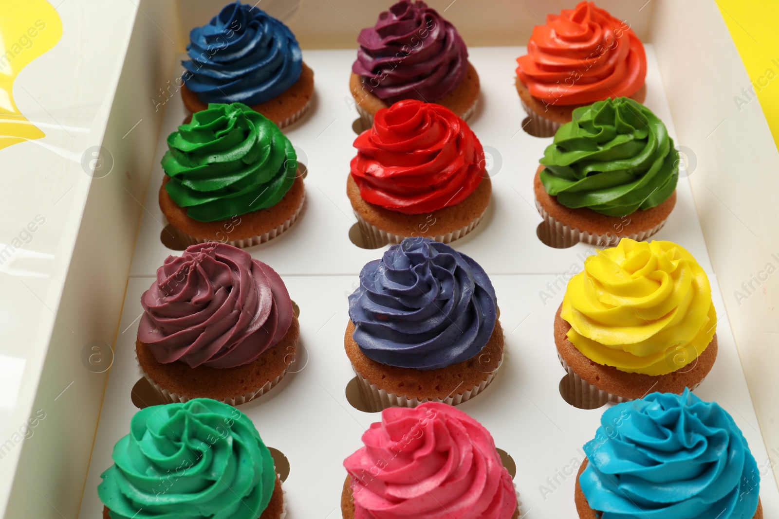 Photo of Different cupcakes with cream in box, closeup