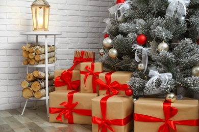 Photo of Beautiful decorated Christmas tree and gift boxes in living room