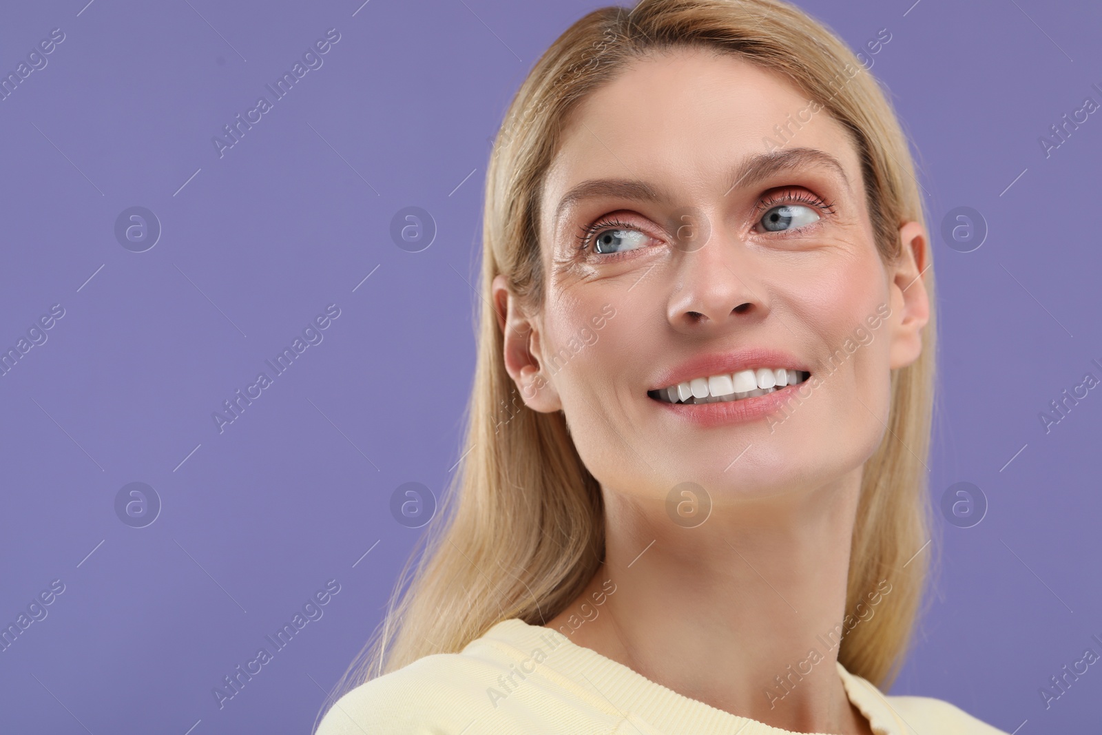 Photo of Woman with clean teeth smiling on violet background, space for text