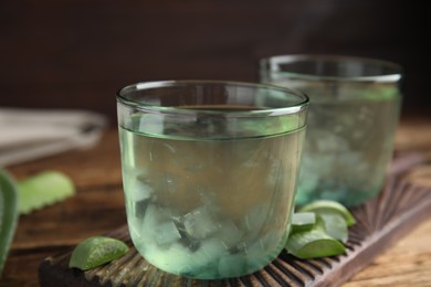 Photo of Fresh aloe drink in glasses on table, closeup