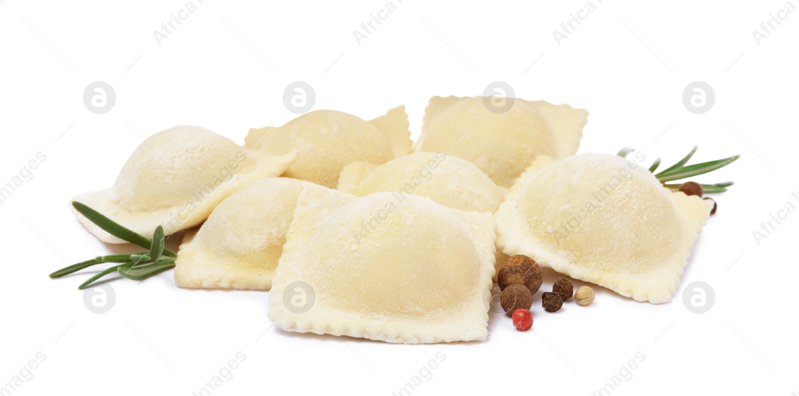 Photo of Uncooked ravioli, rosemary and peppercorns on white background