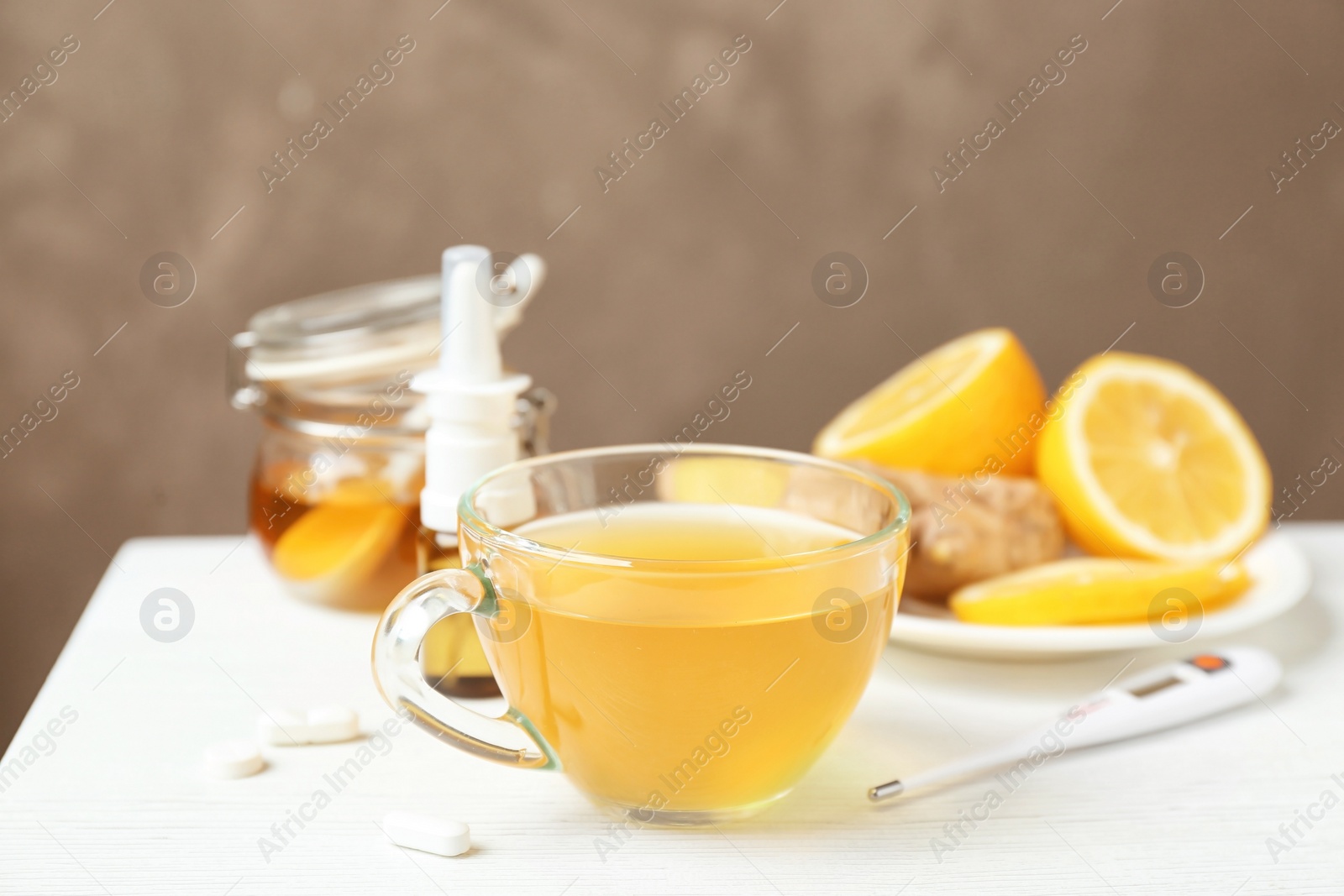 Photo of Cup with hot tea for cold on table