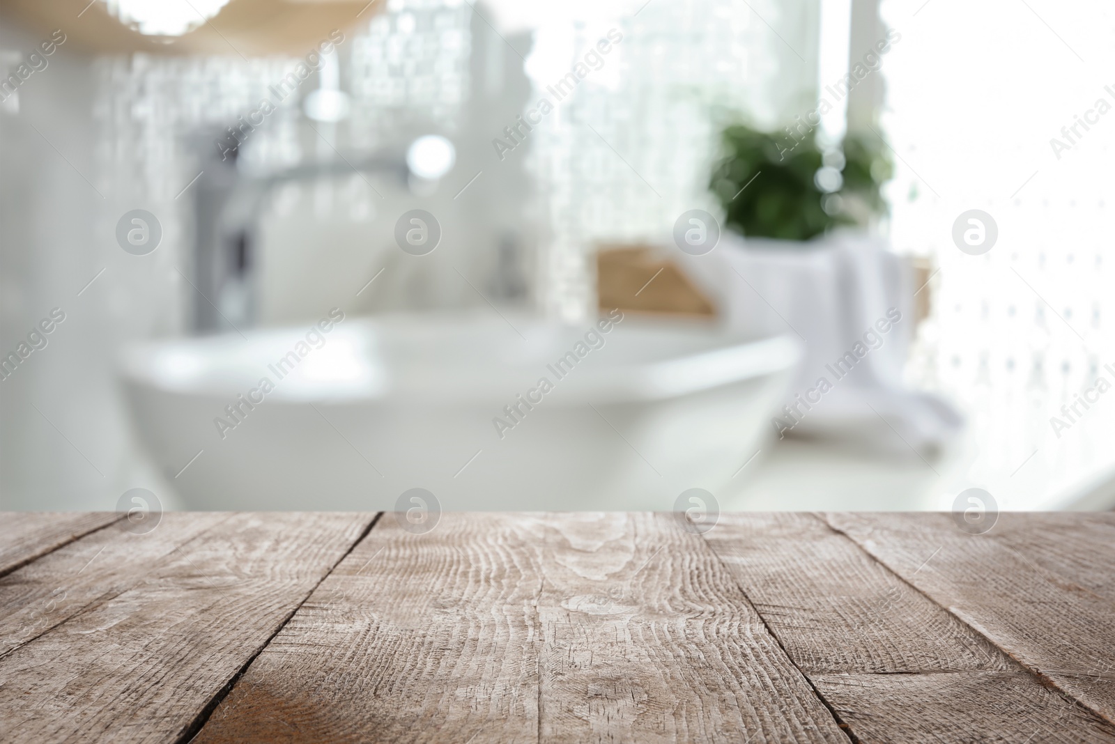 Image of Empty wooden table and blurred view of stylish bathroom interior