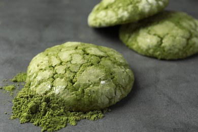 Photo of Tasty matcha cookies and powder on grey table, closeup