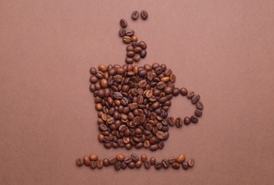 Photo of Cup of hot drink, composition made with coffee beans on brown background, flat lay