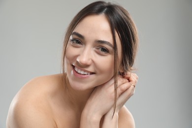 Portrait of beautiful woman on grey background